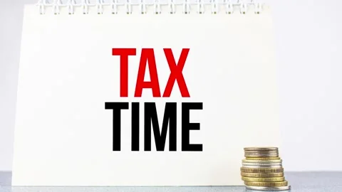 TAX TIME the text on the notepad on the coin. Tax time concept,animation. Stock Footage 277214270