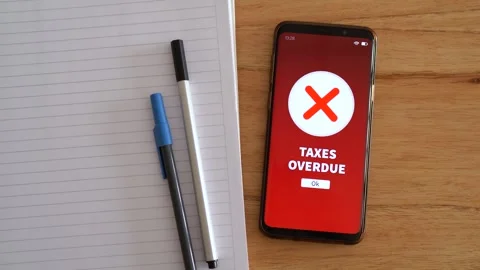 Taxes overdue notification on smartphone. Concept of problems paying taxes on Stock Footage 297458712