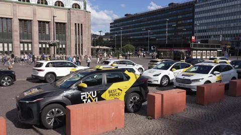 Taxi cabs lined up waiting outside central train station in Helsinki, Finland. Stock Footage 341500587