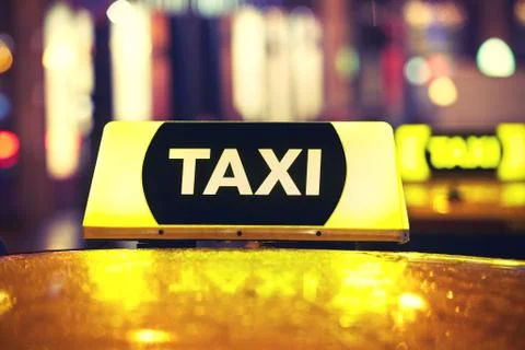 Taxi car on the street at night Stock Photos