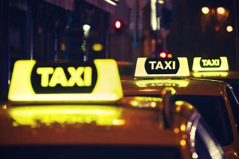 Taxi car on the street at night Stock Photos