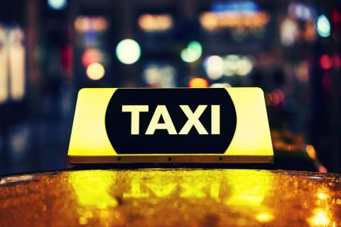 Taxi car on the street at night Fotos Stock