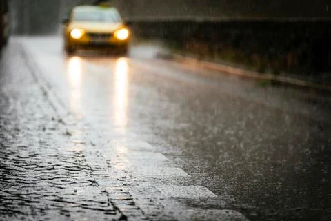 Taxi circulating on wet asphalt while its raining. Stock Photos