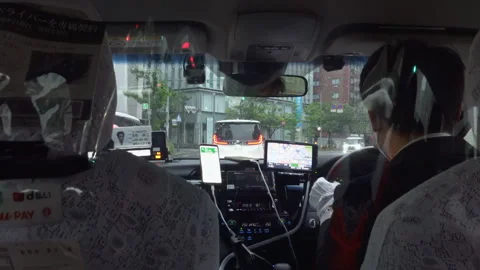 Taxi driver driving through traffic of Hakata in rainy morning Stock Footage 242799452