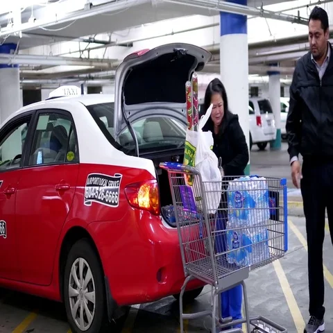 Taxi driver helping customer to move bottle water to trunk at Walmart store Stock Footage 69430896