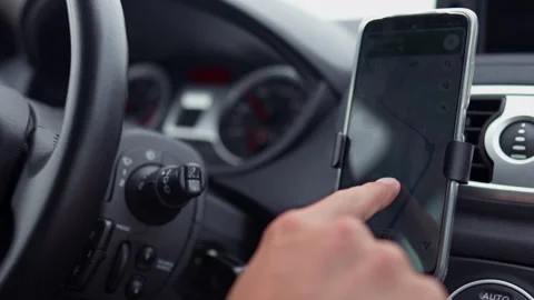 A taxi driver plots a route map on a smartphone by swiping a finger across t Stock Footage 219867770