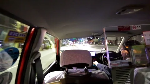 A taxi driver with tourists drive along the early morning roads. Tokyo, Japan Stock Footage