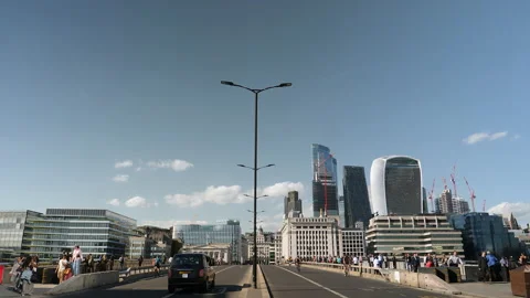 A taxi passes a bridge in the  business district. London, United Kingdom. Stock Footage 211337341
