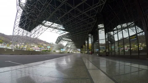 A taxi passes under the metal structures of the airport building Stock Footage 129713617