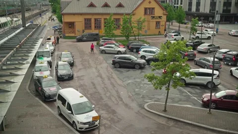 Taxi queue and busy parking lot at Jyvaskyla Travel Centre in Finland Stock Footage 313219223