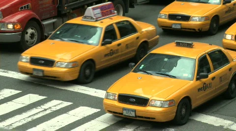 Taxi Traffic file through an intersection Stock Footage 331643