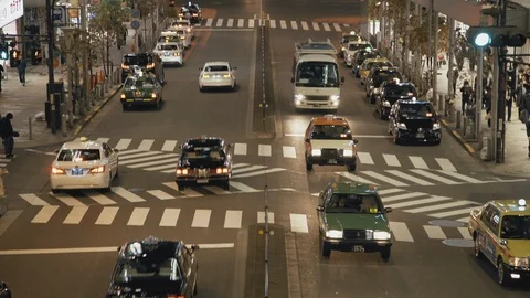 Taxis driving down road in Shinjuku Tokyo Stock Footage