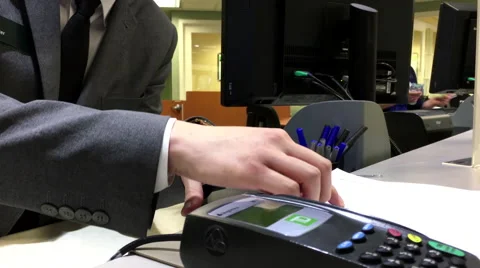 TD clerk explaining account fee for customer inside TD Bank 動画素材 63851024