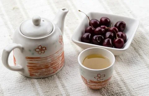Tea and cherries Stock Photos