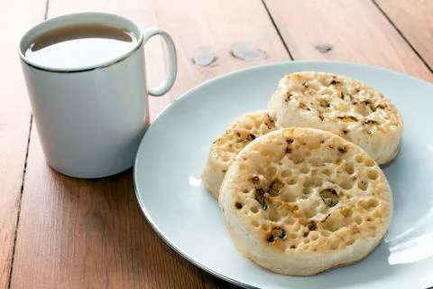 Tea and Crumpets on Wooden Table 写真素材