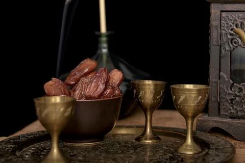 Tea and dried dates on a old wooden table. Stock Photos