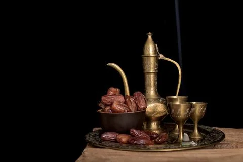 Tea and dried dates on a old wooden table. Stock Photos