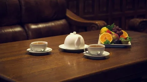 Tea and Fruit on Solid Wood Table Stylish Lounge with Leather Sofas Stock Footage 262562809