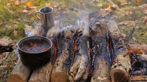 Tea and a mug on the campfire in the campaign Stock Footage 84148677