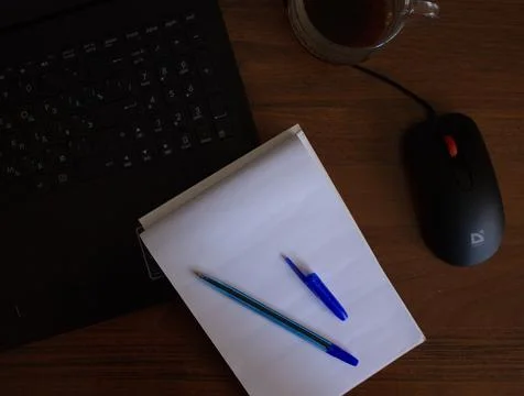 Tea and notebook on the desktop Stock Photos