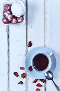 Tea and strawberries with marshmallows Stock Photos