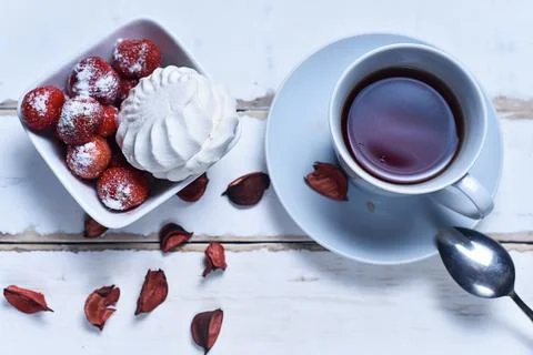 Tea and strawberries with marshmallows Stock Photos