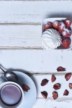 Tea and strawberries with marshmallows Stock Photos