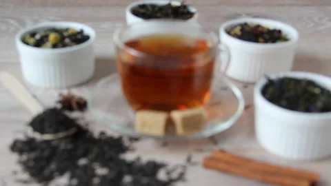 Tea assortment. Various kinds of tea in bowl. Prepared tea in a cup with sugar. Stock Footage 155898260