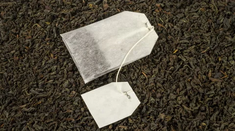 Tea  bag on background of tea leaves close up rotation 4K Stock Footage 50236642