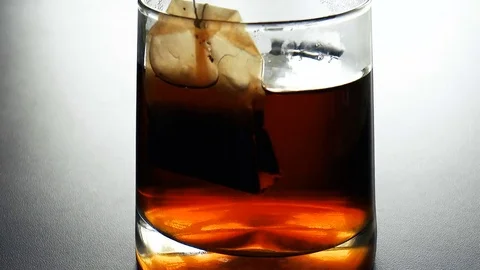 Tea bag is brewed in a cup of boiling water Stock Footage 79458227