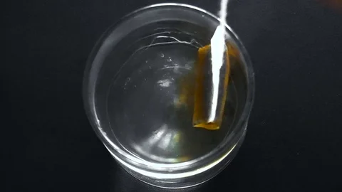 Tea bag is brewed in a cup of boiling water Stock Footage 79539330