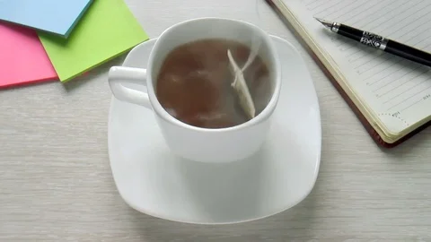 Tea bag is brewed in a cup Stock Footage 80720595