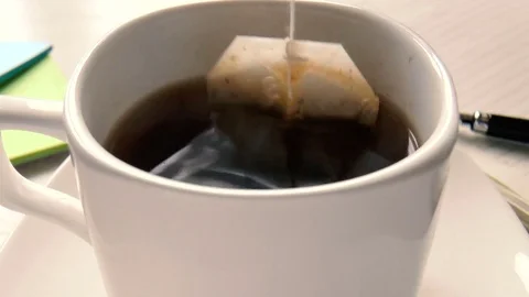 Tea bag is brewed in a cup Stock Footage 80856793