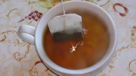 Tea from a bag is brewed in a cup Stock Footage 144760011