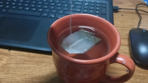 Tea bag dipping on a cup Stock Footage 148402294
