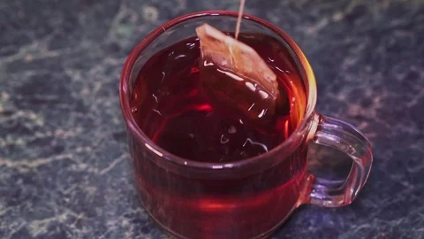 Tea bag dunk in a cup of tea closeup Stock Footage 102915732