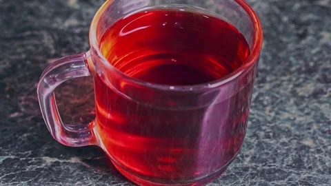 Tea bag dunk in a cup of tea and mixed with a stainless steel spoon closeup Stock Footage 102916049