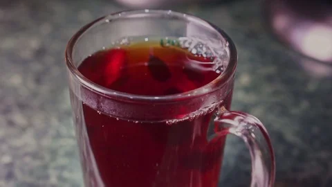 Tea bag dunk in a cup of tea and mixed with a stainless steel spoon close-up Stock Footage 102916177