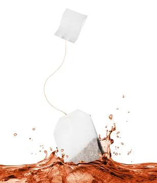 Tea bag falls into splashes of tea on white background Stock Photos