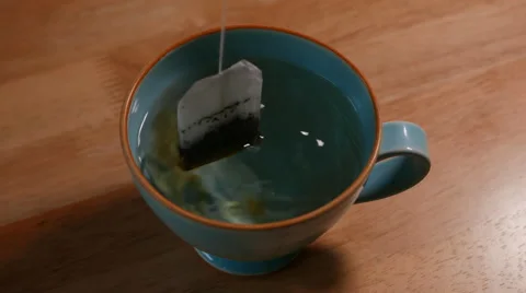 Tea bag gets dipped in hot water Video stock 44479993