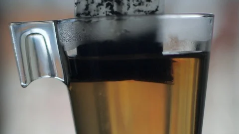 Tea bag in glass cup slow motion Stock Footage 116676964