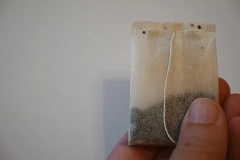 Tea Bag in Hand Calm Routine Concept Copy Space Photos