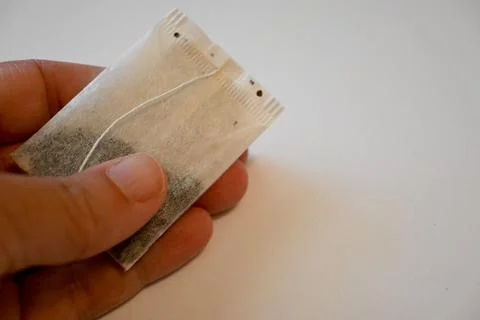 Tea Bag in Hand Calm Routine Concept Copy Space Photos
