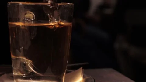 Tea bag has being soaking in the transparent glass cup filled with hot wate.. Stock-Footage 276866551