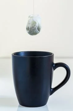 Tea bag is hung in a cup Stock Photos