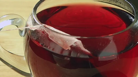 Tea bag is lowered into the cup Stock Footage 74067647