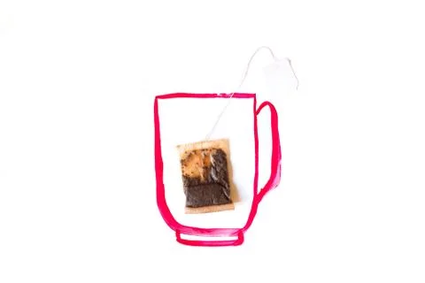 Tea bag in a painted red mug, white background Stock Photos