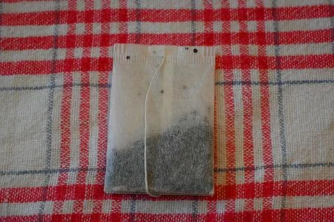 Tea Bag on Red Checkered Tablecloth Close-Up, Home Tea Time Concept Stock Photos