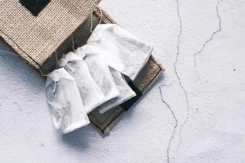 Tea bag with small bag on table close up Stock Photos