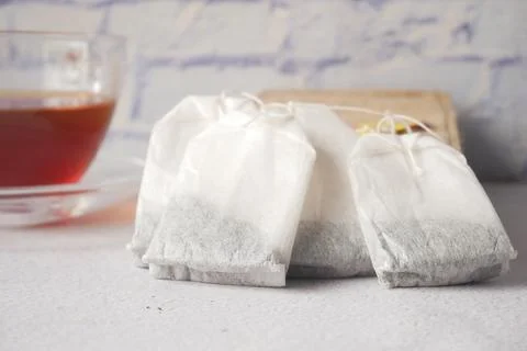 Tea bag with small bag on table close up Stock Photos